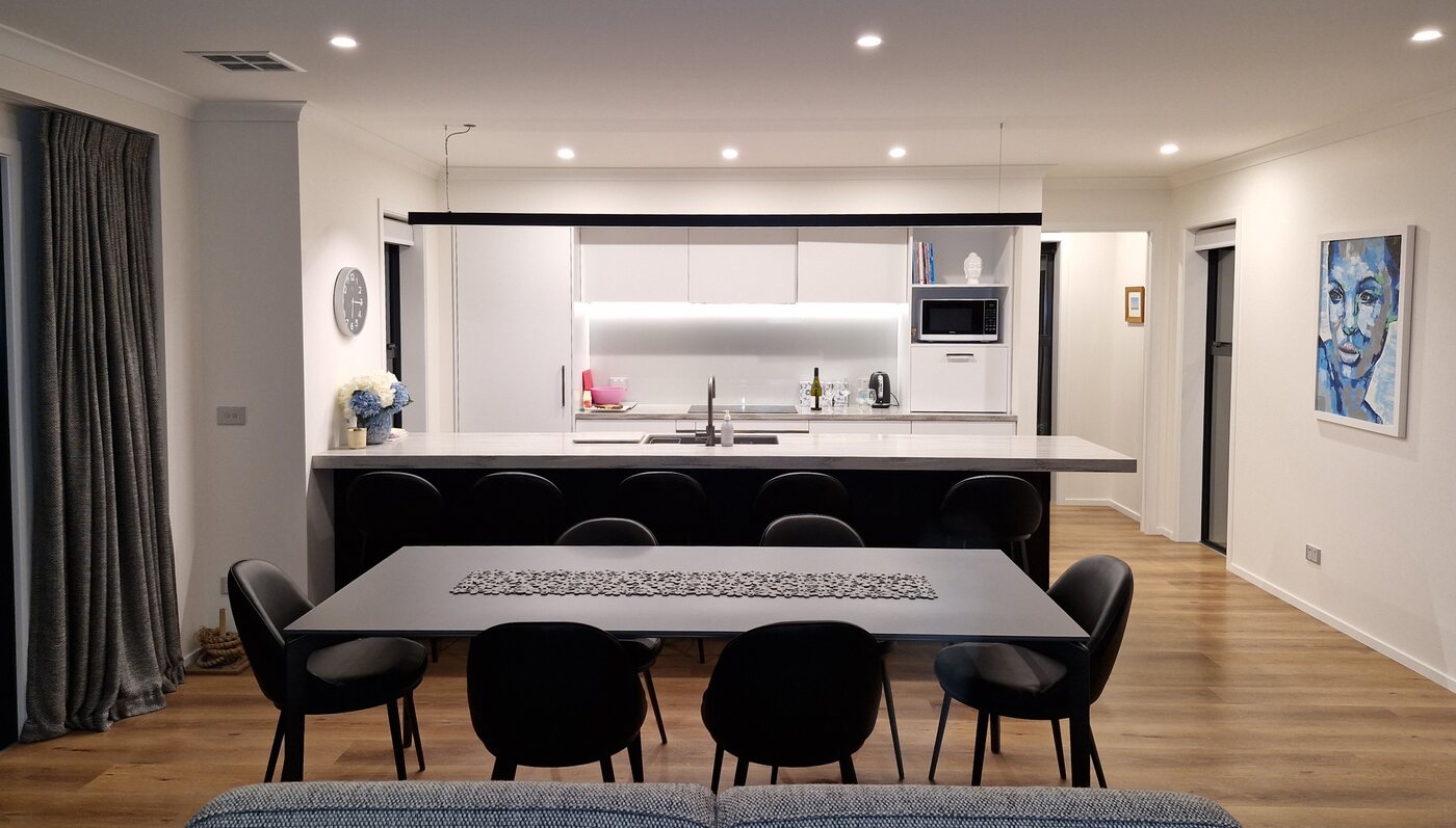 Kitchen and dining area with recessed LED downlights and under-cabinet lighting